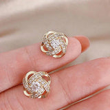 Pendientes florales dorados en espiral con cristales