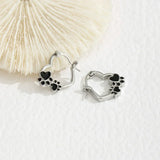 Pendientes Huggie con diseño de corazón y acabado en esmalte negro.
